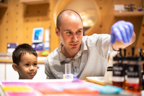 Family exploring hands-on exhibits with a Tech Interactive membership